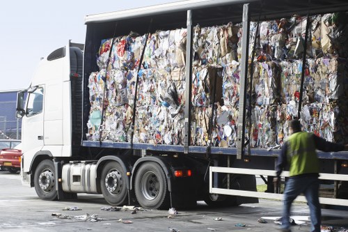Operatives loading bulky waste into a van during a flat clearance job